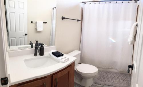 a bathroom with a sink and a toilet and a shower at ️Full Kitchen11 bedbath in this home at discountnear canyonsBoat Parking in Page