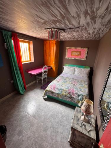 a bedroom with a bed and a table in it at Hotel Recreacional Marcelandia Santa Rosa de Cabal in Santa Rosa de Cabal