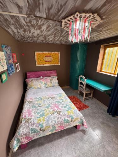 a small bedroom with a bed and a table at Hotel Recreacional Marcelandia Santa Rosa de Cabal in Santa Rosa de Cabal