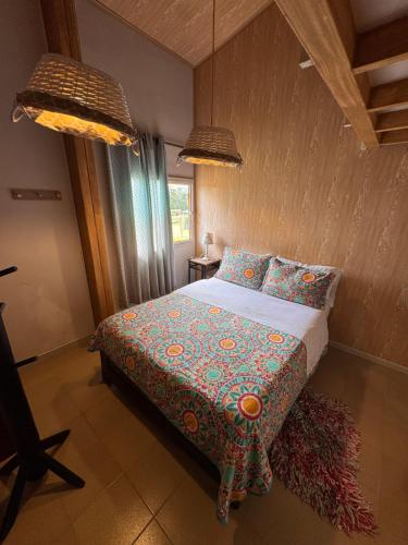a bedroom with a bed in a room with two lamps at Hotel Recreacional Marcelandia Santa Rosa de Cabal in Santa Rosa de Cabal