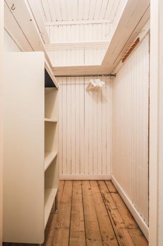 an empty closet with a white wall and a ceiling at Comfort Meets Style in Central Norberg in Norberg
