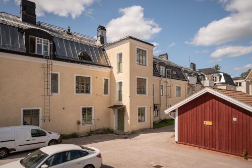 a group of buildings with cars parked in a parking lot at Comfort Meets Style in Central Norberg in Norberg