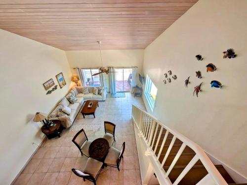 a living room with a couch and a staircase at Bimini Tides in South Bimini