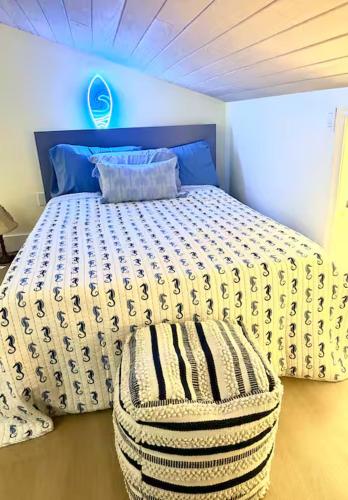 a bedroom with a bed with a ottoman in it at Bimini Tides in South Bimini