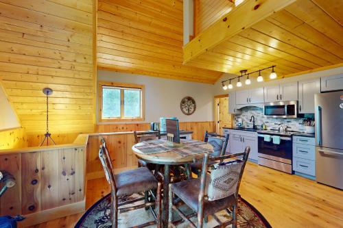 a kitchen with a table and chairs in a cabin at Paradox Lake Lookout in Schroon Lake