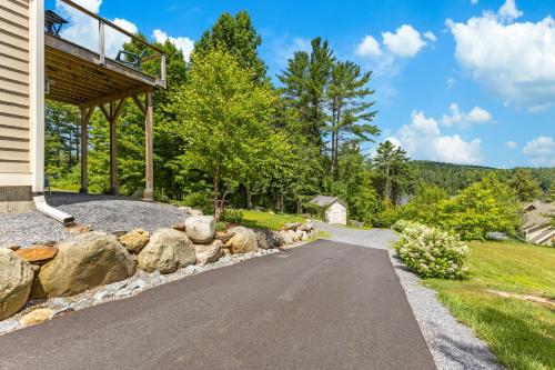 a driveway leading to a house with a rock wall at Paradox Lake Lookout in Schroon Lake