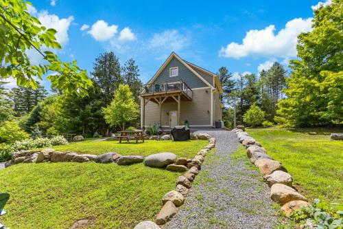 a home with a stone path leading to a house at Paradox Lake Lookout in Schroon Lake