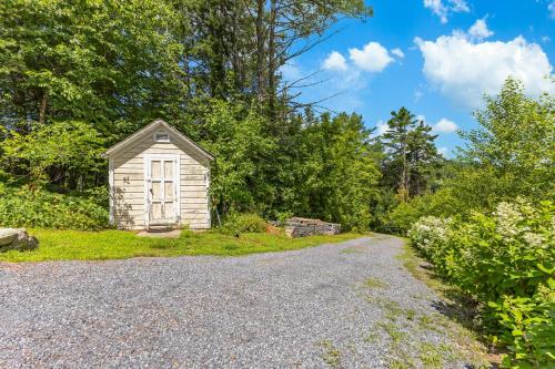a small shed on the side of a gravel road at Paradox Lake Lookout in Schroon Lake