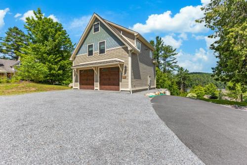 a house with a garage on a driveway at Paradox Lake Lookout in Schroon Lake