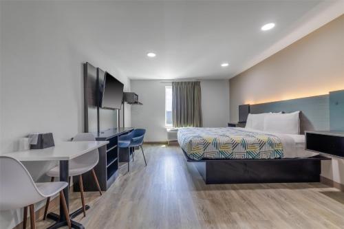 a hotel room with a bed and a desk at Motel 6 Gonzales, LA Baton Rouge Geismar Prairieville I 10 in Gonzales