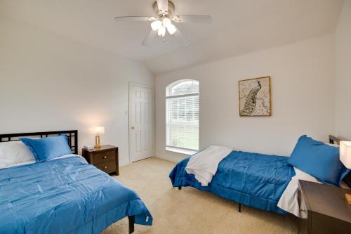 a bedroom with two beds and a ceiling fan at Game Room and Bar Secluded Getaway in Farmersville in Nevada