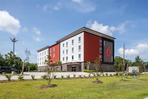 a building with a large sign on the side of it at Studio 6 Gonzales, LA Baton Rouge Geismar Prairieville I 10 in Gonzales