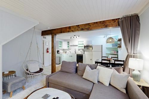 a living room with a couch and a dining room at West Ashley Abode in Charleston
