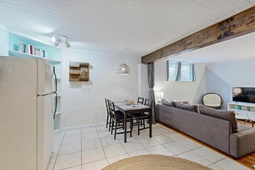 a kitchen and living room with a couch and a table at West Ashley Abode in Charleston