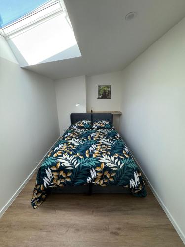 a bedroom with a bed in a room with a window at À Lens comme à la maison in Lens