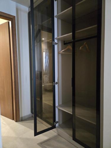 a closet with glass doors in a room at Drymadhes Villas & appartments in Himare
