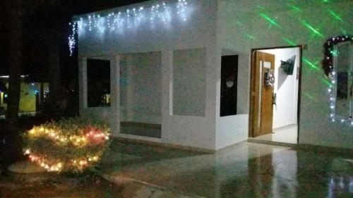 a building with christmas lights on it at night at Habitacion Pauvemar en Coveñas in Coveñas