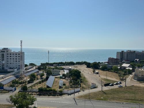 a view of a city with the ocean in the background at Студия с Видом на Море, 9-2 in Chornomorsk