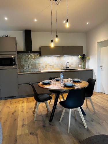 a kitchen with a table and chairs in a kitchen at Holiday House Nature in Lier