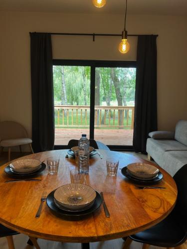 a wooden table with plates and glasses on top of it at Holiday House Nature in Lier