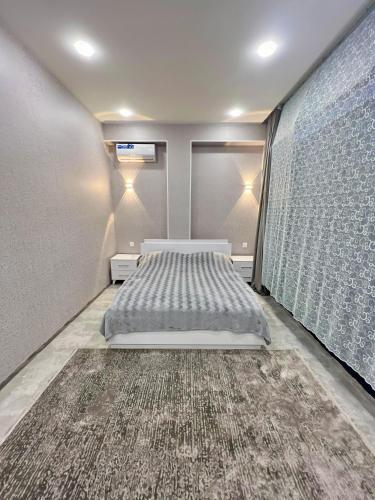 a bedroom with a bed and a large window at AZ Villa in Gabala in Gabala