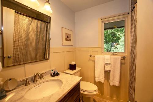 a bathroom with a sink and a toilet and a window at Coates By Hauserman Rentals in Tahoe City