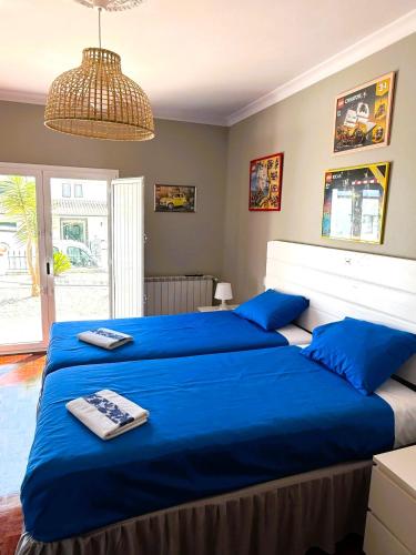 a bedroom with a large blue bed with blue pillows at Delux LEIRIA Side in Leiria