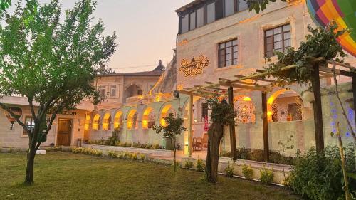 a building with windows and trees in front of it at CAPPANAR CAVE HOTEL in Nar