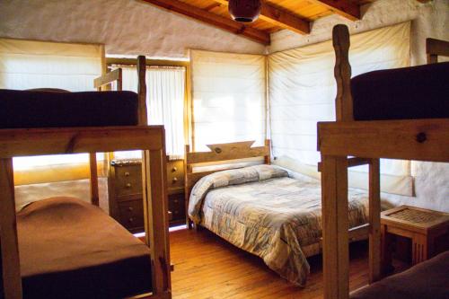 a bedroom with two bunk beds and a window at Cabañas RuizSeñor in Mazamitla
