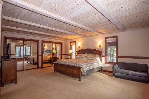 a bedroom with a bed and a tv and a couch at Highlands Lodge By Hauserman Rentals in Tahoe City