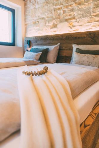 a bed with a blanket on top of it at Chalet Hideaway Alpi in Garmisch-Partenkirchen