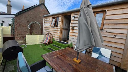 an umbrella sitting on top of a wooden table at Oor Hoose in Blairgowrie
