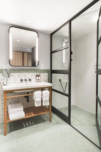 a bathroom with a sink and a mirror at Hotel Indigo Lima Miraflores by IHG in Lima