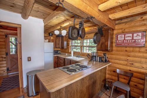 a kitchen with wooden walls and a wooden counter top at Little Bear Cabin By Hauserman Rentals in Tahoe Vista