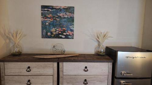 a kitchen with a refrigerator and a painting on the wall at Golden House in Santa Clarita