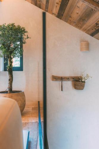 a wall with a potted tree in a room at Chalet Hideaway Alpi in Garmisch-Partenkirchen