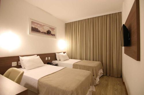 Postelja oz. postelje v sobi nastanitve Quarto duplo Samba Hotel Linhres