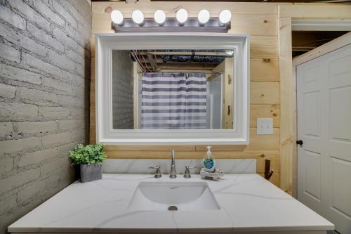 a bathroom with a sink and a mirror at Cozy Log Cabin in Jim Thorpe in Jim Thorpe