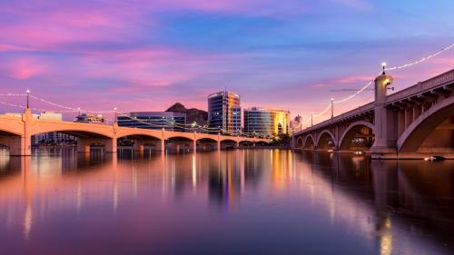 a bridge over a river with a city in the background at Charming private guest house with pool in Tempe