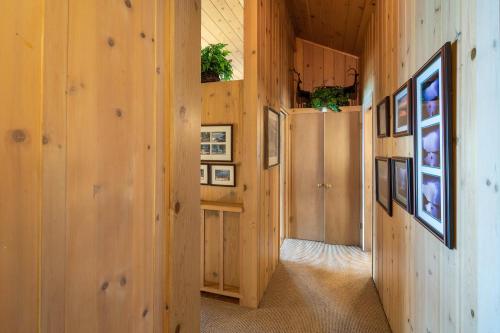 a hallway with wood paneling and pictures on the walls at McCown Lakefront By Hauserman Rentals in Tahoma