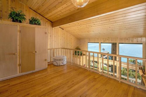 an empty room with a balcony with a view of the ocean at McCown Lakefront By Hauserman Rentals in Tahoma