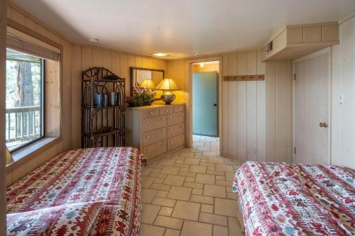 a bedroom with two beds and a dresser at McCown Lakefront By Hauserman Rentals in Tahoma