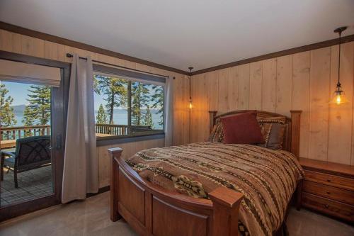 a bedroom with a large bed and a balcony at McKinney Cove By Hauserman Rentals in Homewood