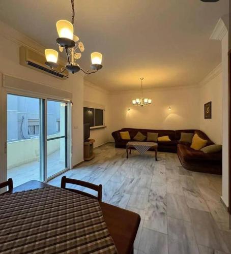 a large living room with a couch and a living room at Tea apartment in Aqaba
