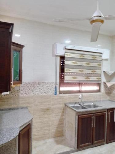 a kitchen with a sink and a counter top at Tea apartment in Aqaba