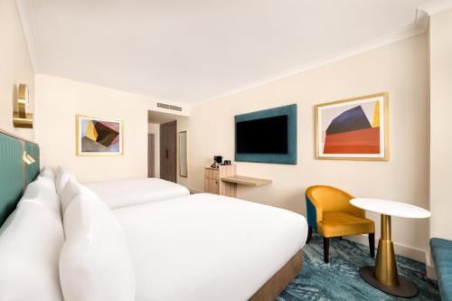 a hotel room with a bed and a desk at Crowne Plaza Gerrards Cross by IHG in Beaconsfield