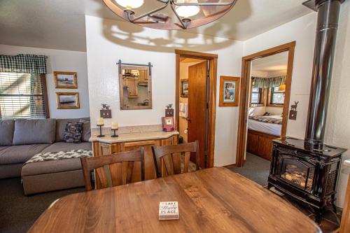 a living room with a table and a couch and a fireplace at Franciscan Lakeside # 29 By Hauserman Rentals in Tahoe Vista