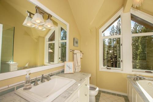 a bathroom with a sink and a large mirror at Snowglobe By Hauserman Rentals in Tahoe City