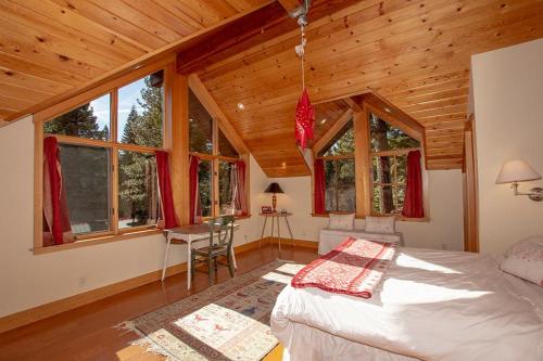 a bedroom with a bed in a wooden cabin at Snowglobe By Hauserman Rentals in Tahoe City