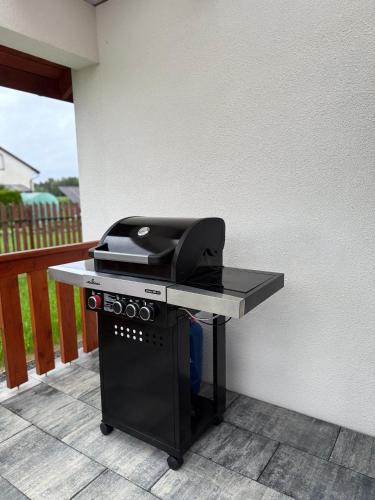 a table with a grill on a patio at Zator Domki Dreampark in Zator